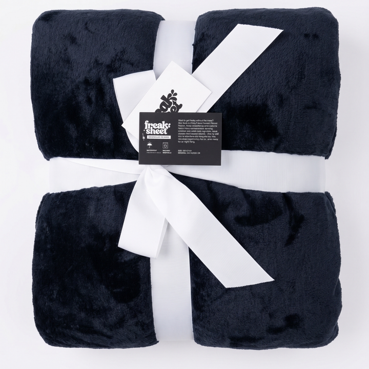 Midnight charcoal blue Minky Sherpa fleece sex blanket by Freak Sheet, folded and tied with a white ribbon, featuring a soft plush texture.