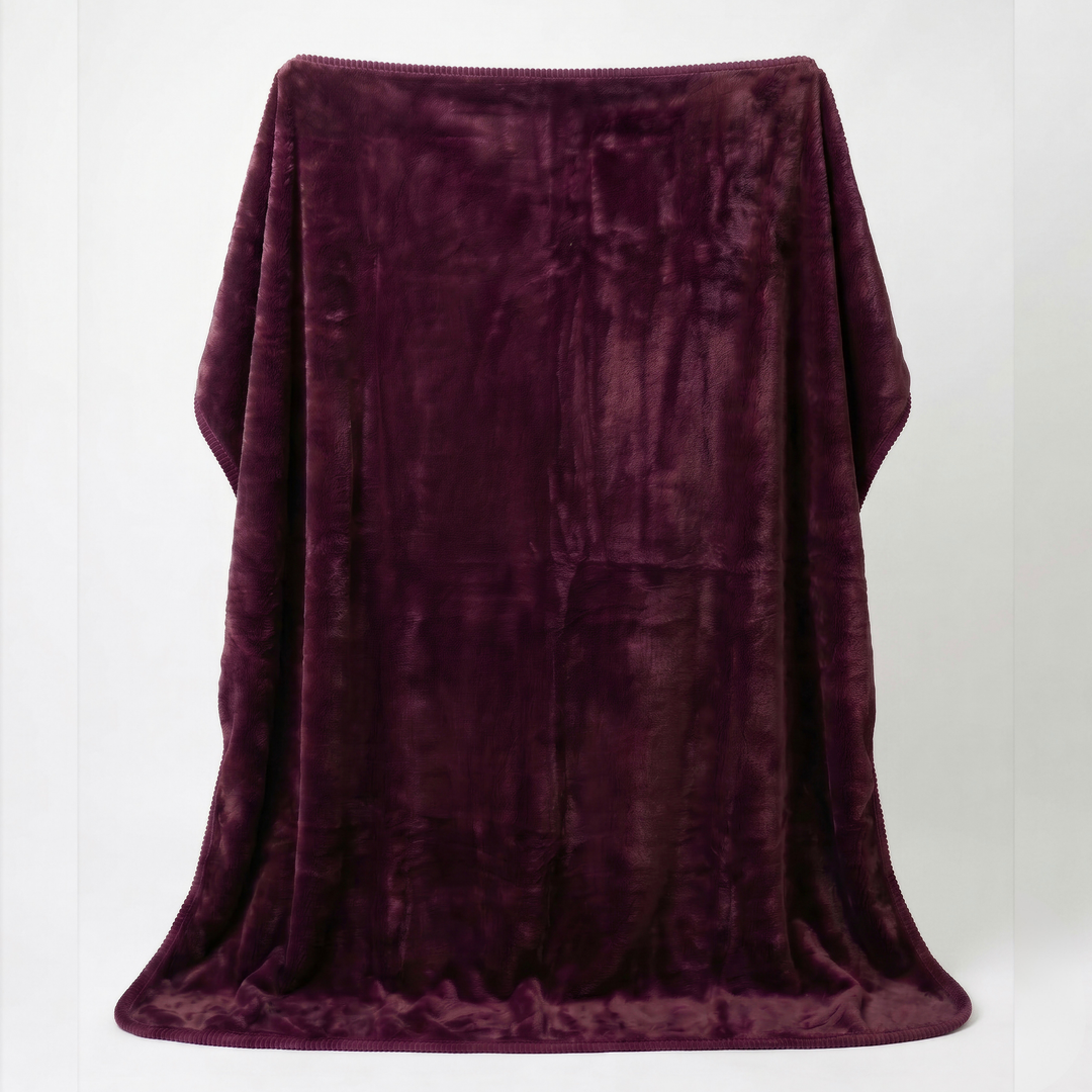 Plum colour luxury plush fleece sex blanket draped over white background showcasing its rich colour, silky softness, and elegant drape.