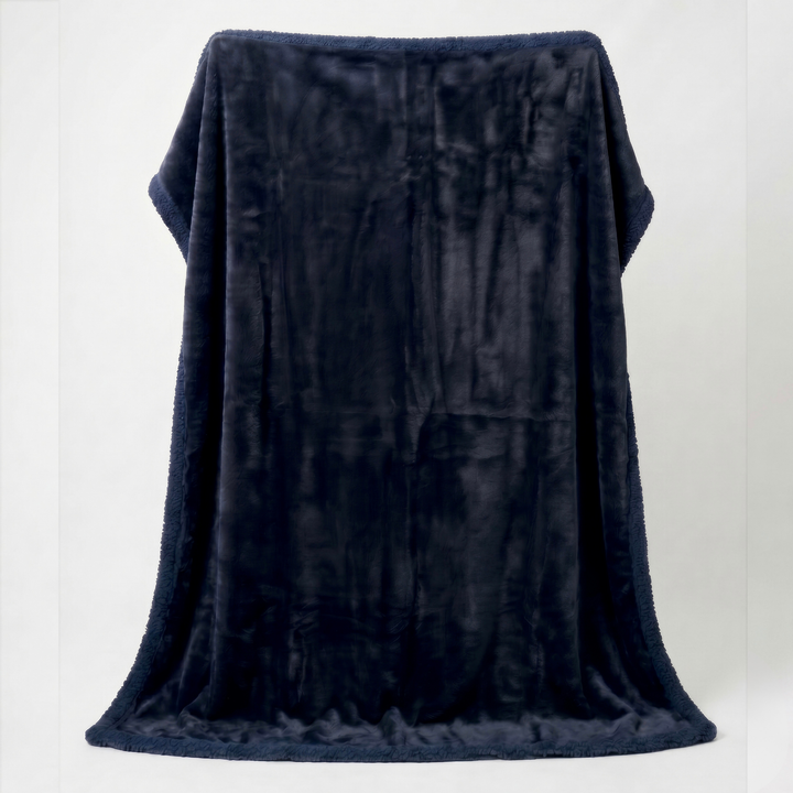 Midnight charcoal blue Minky Sherpa fleece sex blanket draped over a white background, displaying its luxurious plush finish and cosy warmth.