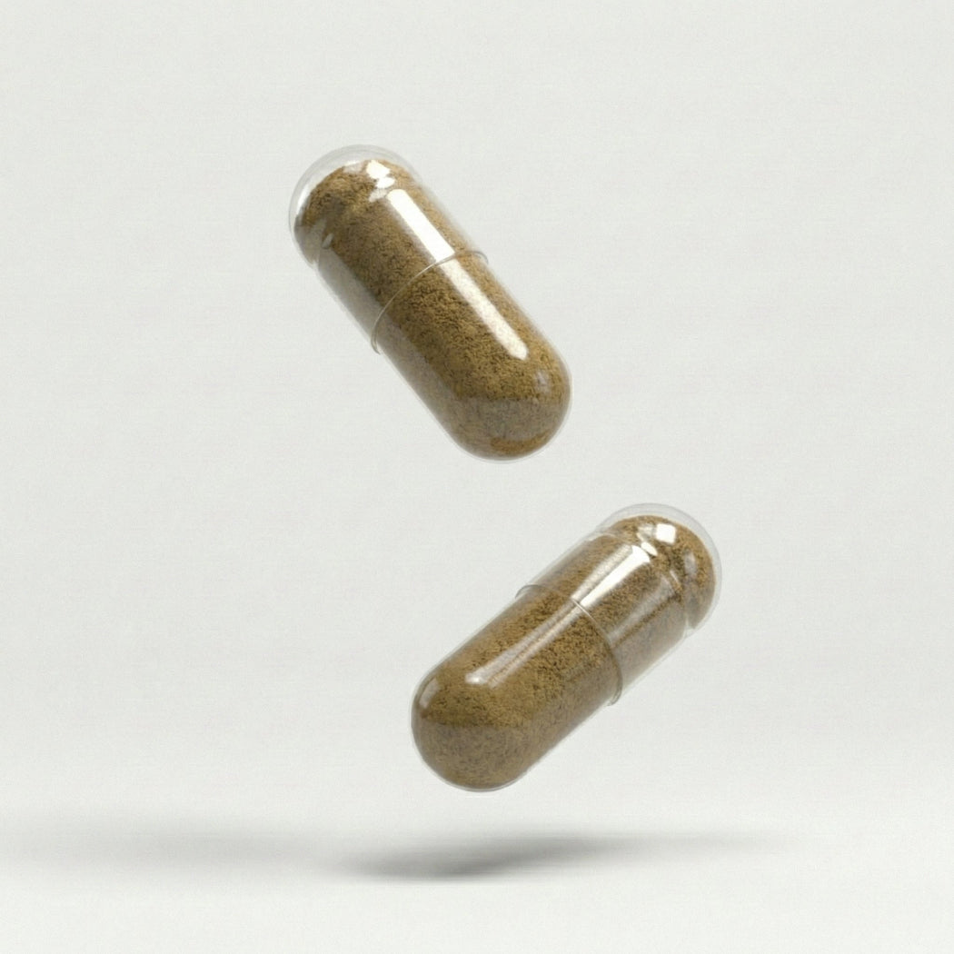 Two brown libido supplement capsules on a white background