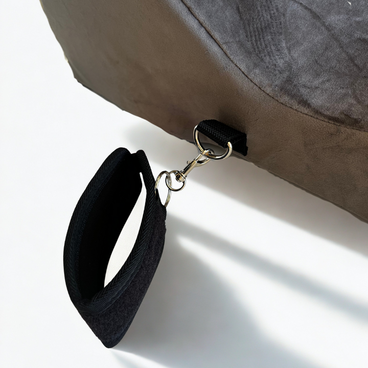 Adjustable black wrist restraint attached to Bumpy Cuddles pillow restraint cover for secure and playful bedroom positioning