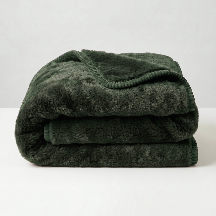 A folded forest color luxury plush fleece freak sheet on a white background