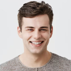 Man with a smile on a plain background