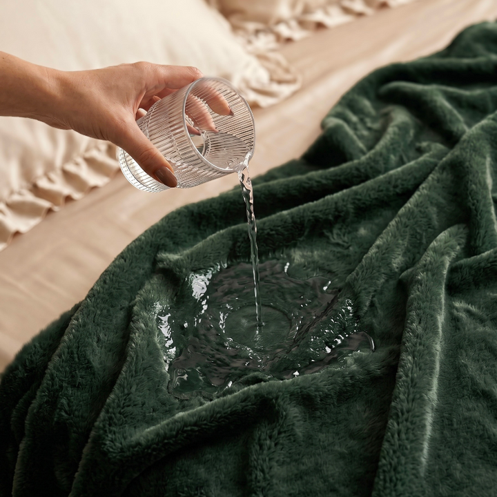 pouring water on green colour freak sheet waterproof blanket