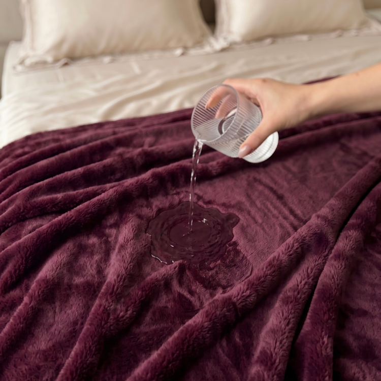 pouring water on plum colour freak sheet waterproof blanket